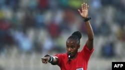 FILE - Rwandan referee Salima Mukansanga gestures during the Group B Africa Cup of Nations 2021 fixture between Zimbabwe and Guinea, Yaounde, January 18, 2022. 