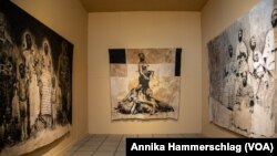 A series by Ivorian artist Roméo Mivekannin hangs at the Ancien Palais de Justice on May 21, 2022 as part of the Dakar Biennale. 