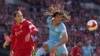 Nathan Ake dari Manchester City melompat untuk mengejar bola di sebelah Virgil van Dijk dari Liverpool, kiri, di stadion Wembley di London, Sabtu, 16 April 2022. (Foto: AP)