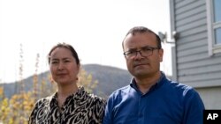 Uyghur couple Mihrigul Musa, left, and Abduweli Ayup pose for a photograph in their yard in Bergen, Norway on May 8, 2022.
Ayup and Musa knew friends and relatives sentenced to prison in China. (AP Photo/Paul Johannessen)