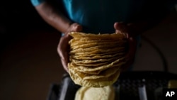 A worker packages tortillas to sell for 20 Mexican Pesos per kilogram, about one dollar, at a tortilla factory in Mexico City, May 9, 2022.