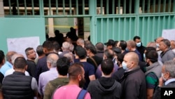 People line up to vote during parliamentary elections in Beirut, Lebanon, May 15, 2022. 