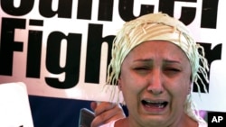 Cancer patient Rita Chidiac cries during a protest by dozens of cancer patients who railed at shortages in medications amid Lebanon's economic problems, near the presidential palace in Baabda, east of Beirut, May 20, 2022.