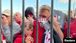 FILE - Liverpool fans react as they queue to access Stade de France before Champions League Final at Stade de France, Saint-Denis near Paris, May 28, 2022- 