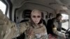 FILE - Yuliia Paievska, known as Taira, and her driver, Serhiy, sit in a vehicle in Mariupol, Ukraine, March 9, 2022. She was freed by Russian forces June 17, 2022, three months after she was taken captive on the streets of Mariupol.