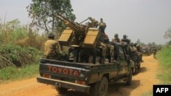 Des véhicules de militaires des FARDC escortent des véhicules civils transportant des marchandises de Beni vers Komanda sur la route nationale, le 19 mars 2022.