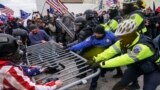FILE - Rioters try to break through a police barrier at the Capitol in Washington on Jan. 6, 2021. (AP Photo/John Minchillo, File)