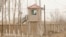 FILE - A security person watches from a guard tower around a detention facility in Yarkent County in northwestern China's Xinjiang Uyghur Autonomous Region, March 21, 2021.