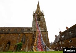 "Flower Tower" yang terdiri dari lebih 4.300 bunga rajutan dan kaitan buatan tangan terlihat di Gereja All Saints, menjelang perayaan Platinum Jubilee untuk Ratu Elizabeth dari Inggris, di Middleton Cheney, Inggris, 26 Mei 2022. (Foto: Reuters)