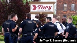Police officers secure the scene after a shooting at TOPS supermarket in Buffalo, New York, U.S. May 14, 2022. REUTERS/Jeffrey T. Barnes