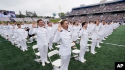 Graduating midshipmen take their oath during the U.S. Naval Academy's graduation and commissioning ceremony at the Navy-Marine Corps Memorial Stadium in Annapolis, Maryland, May 27, 2022.