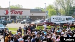 총격 사건이 발생한 미국 뉴욕주 버펄로의 '탑스' 슈퍼마켓 앞에 15일 희생자 추모 기도회 참가자들이 모여 있다. 