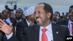File - Newly elected Somalia President Hassan Sheikh Mohamud waves after he was sworn-in, in the capital Mogadishu, on May 15, 2022.