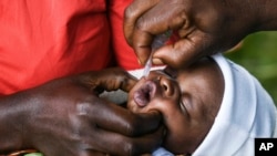 FILE - A baby receives a polio vaccine in Lilongwe, Malawi, March 20, 2022. In neighboring Mozambique, health authorities on May 18, 2022, declared an outbreak of wild poliovirus after confirming that a child in the country's Tete province had contracted the disease.
