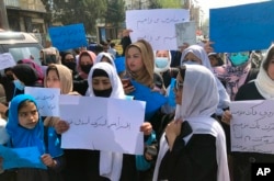 FILE - Afghan women protest in Kabul, Afghanistan, March 26, 2022. Afghanistan's Taliban rulers refused to allow dozens of women to board several flights because they were traveling without a male guardian.