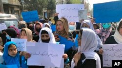 FILE - Afghan women protest in Kabul, Afghanistan, March 26, 2022. Afghanistan's Taliban rulers refused to allow dozens of women to board several flights because they were traveling without a male guardian.