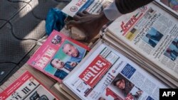 FILE - A local newspapers articles showing photos of Ethiopian Prime Minister Abiy Ahmed and leaders of the Tigray´s People Liberation Front (TPLF) in a downtown area of the city of Addis Ababa, November 3, 2021