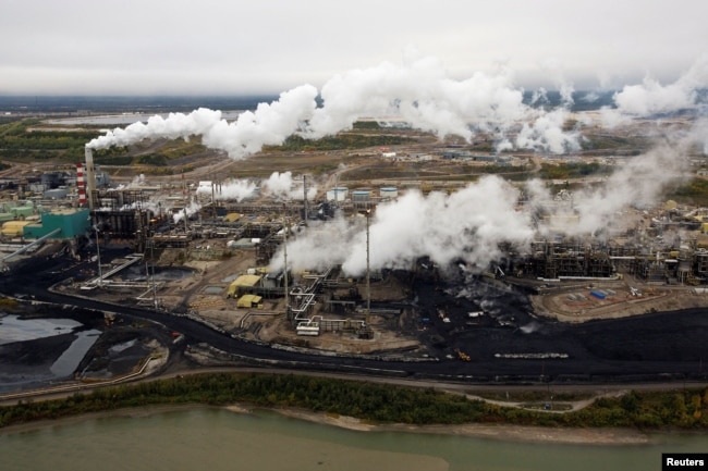 FILE - A Suncor tar sands processing plant stands near the Athabasca River at the company's mining operations near Fort McMurray, Alberta, Canada, Sept. 17, 2014.S