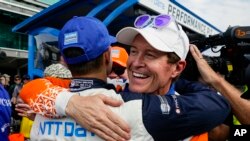 Scott Dixon, of New Zealand, right, celebrates winning the pole with second place finisher Alex Palou, of Spain, during qualifications for the Indianapolis 500 auto race at Indianapolis Motor Speedway in Indianapolis, Indiana, May 22, 2022.