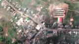 A satellite image shows damaged buildings and a tank on a road, in Lyman, Ukraine May 25, 2022.
