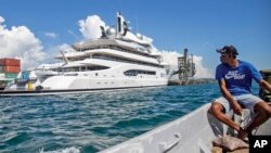 FILE - Boat captain Emosi Dawai looks at the superyacht Amadea where it is docked at the Queens Wharf in Lautoka, Fiji, on April 13, 2022. 