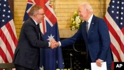FILE - President Joe Biden, right, shakes hands with Australian Prime Minister Anthony Albanese during the Quad leaders summit meeting at Kantei Palace, May 24, 2022, in Tokyo.