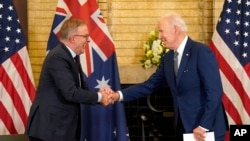 President Joe Biden, right, shakes hands with Australian Prime Minister Anthony Albanese during the Quad leaders summit meeting at Kantei Palace, May 24, 2022, in Tokyo.