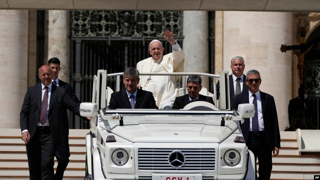 Pope Francis leaves at the end of the weekly general audience in St. Peter's Square at the Vatican, May 18, 2022. 
