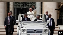 Pope Francis leaves at the end of the weekly general audience in St. Peter's Square at the Vatican, May 18, 2022. 