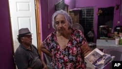 Aurora Falconi shows old photos of her slain daughter, journalist Yessenia Mollinedo Falconi, during her daughter's wake in Minatitlan, Veracruz state, Mexico, May 10, 2022.