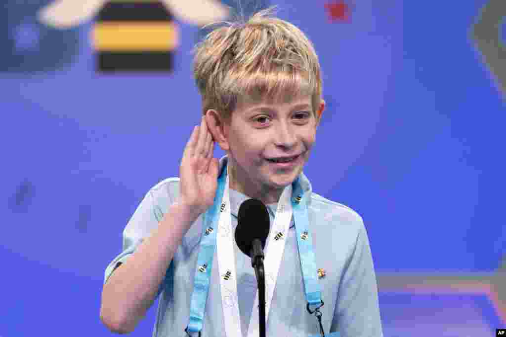 Miles Hubbert, 10, from Centreville, Md., says &quot;what?,&quot; and cups his ear on hearing his word as he competes during the Scripps National Spelling Bee, in Oxon Hill.