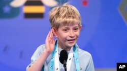 Miles Hubbert, 10, from Centreville, Md., says &quot;what?,&quot; and cups his ear on hearing his word as he competes during the Scripps National Spelling Bee, in Oxon Hill.