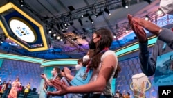 Spellers are given a medal as they advance into the semifinals of the Scripps National Spelling Bee, June 1, 2022, in Oxon Hill, Md. 