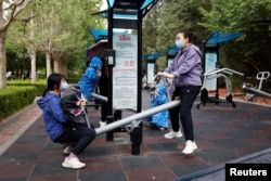 People are seen at Sun Park on the day of its reopening after the government eased some of the COVID-19 restrictions in Beijing, China, May 29, 2022.