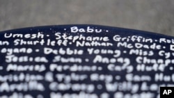 Dan Fischer's surfboard features the nickname of his late father "Babu," top, above the names of other families' lost loved ones.