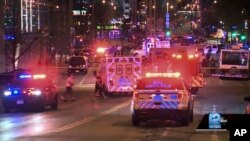 This photo taken from video provided by WISN 12 News shows police responding to the scene of a shooting in Milwaukee, Wisconsin, May 13, 2022.