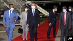 China's Foreign Minister Wang Yi, center, is escorted from his plane on his arrival in Honiara, Solomon Islands, early Thursday, May 26, 2022.