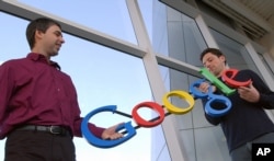 Google co-founder Sergey Brin (right) is a Russian-born immigrant. Google's parent company employs more than 100,000 people. (File photo taken Jan. 15, 2004, at the company's headquarters in Mountain View, California.)