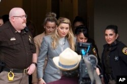 FILE - Actress Amber Heard departs the Fairfax County Courthouse, in Fairfax, Va., May 27, 2022.