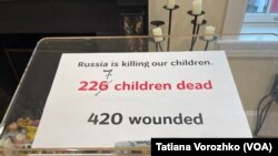 На фото: Виставка в Українському домі у Вашингтоні. "Росія вбиває наших дітей. 227 дітей убито. 420 поранено."
