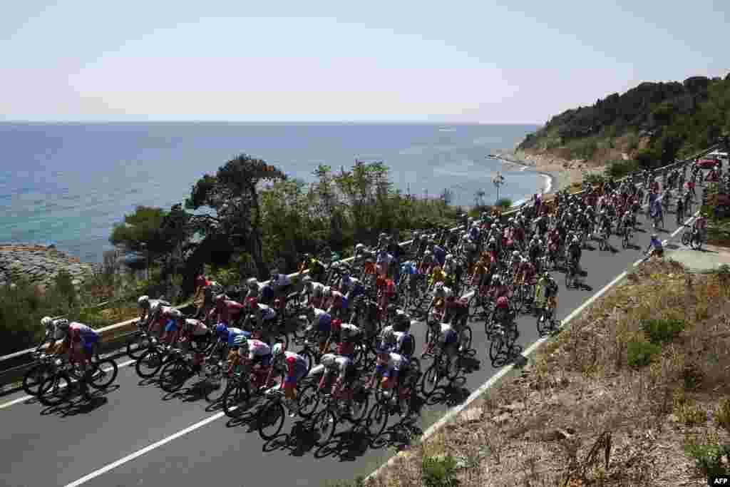 The pack rides near the coastal city of Imperia during the 13th stage of the Giro d'Italia 2022 cycling race, 150 kilometers from San Remo to Cuneo, northwestern Italy.