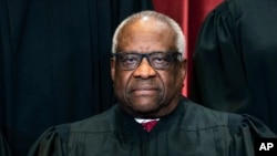 FILE - Associate Justice Clarence Thomas sits during a group photo at the Supreme Court in Washington, April 23, 2021. 