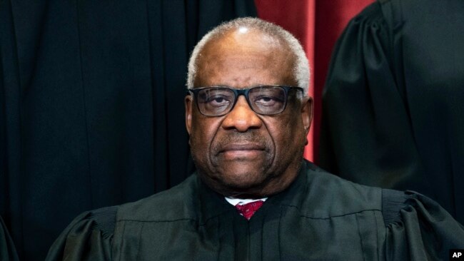FILE - Justice Clarence Thomas sits during a group photo at the Supreme Court in Washington, April 23, 2021.