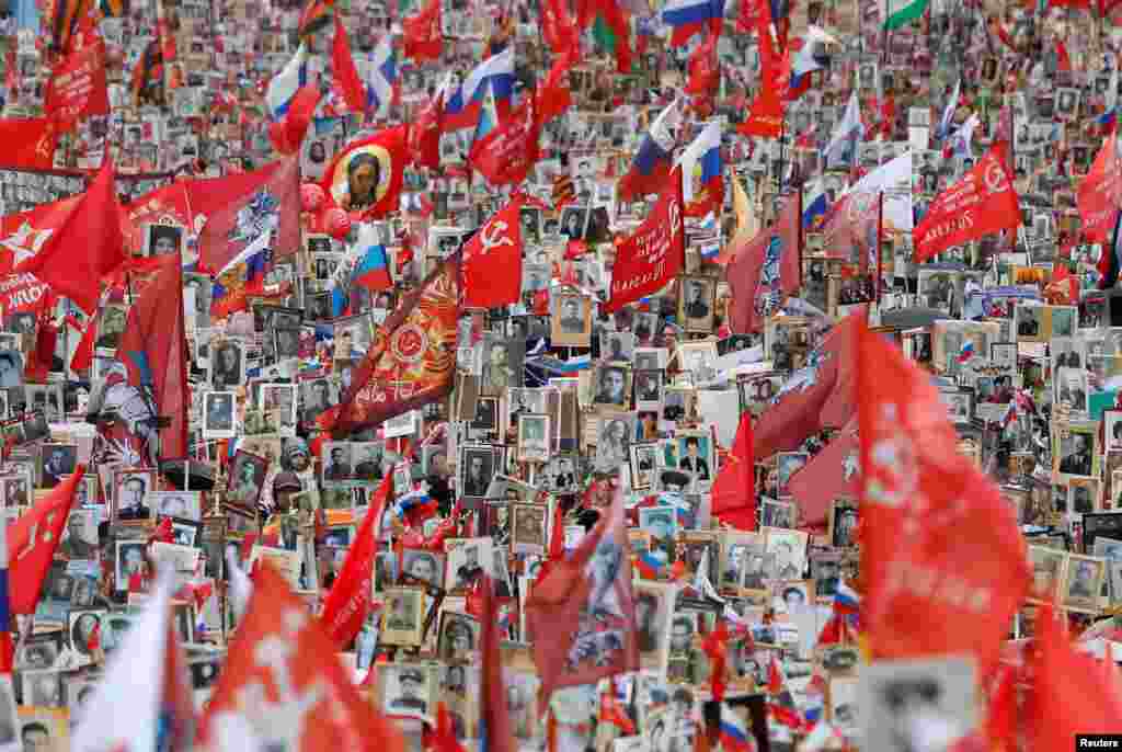 People attend the Immortal Regiment march on Victory Day, which marks the 77th anniversary of the victory over Nazi Germany in World War II, in central Moscow, Russia.