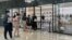 People wearing face masks line up outside a store of French luxury brand Celine, at a reopened shopping mall amid the COVID-19 outbreak in Shanghai, China, May 29, 2022.