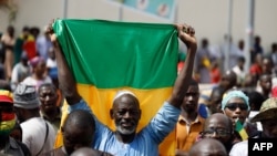 A supporter of Malian Interim President holds up the flag of Mali during a pro-Junta and pro-Russia rally in Bamako on May 13, 2022.