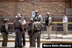 Aparat penegak hukum menjaga lokasi penembakan di Robb Elementary School di Uvalde, Texas, AS, 24 Mei 2022. (Foto: REUTERS/Marco Bello)