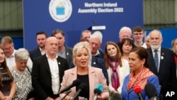 Sinn Fein's Michelle O'Neill, left, and party leader Mary Lou McDonald speak to the media at the Medow Bank election count center in Magherafelt, Northern Ireland, May, 7, 2022. 