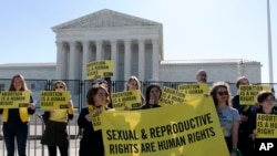 Abortion rights activists protest outside of the U.S. Supreme Court, May 11, 2022 in Washington.