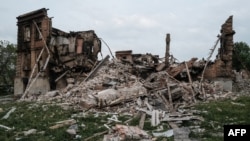 FILE - The remains of a destroyed school are pictured following a Russian military strike on the village of Bilohorivka, Luhansk region, eastern Ukraine, on May 13, 2022. Ukrainian officials say 60 people sheltering in the building's basement died in the attack.